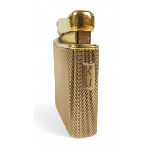 87 - A 9ct gold cased Colibri Monogas lighter, with engine turned decoration, 72.4g gross weight, 9ct gol... 