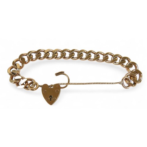 90 - A 9ct yellow gold kerb link bracelet, with heart shaped padlock clasp and attached safety chain, 10.... 