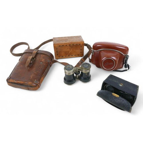 220 - A group of four pairs of binoculars, including a French WWI pair made by Lemaire, Paris, in leather ... 