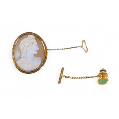 39A - A cameo brooch with yellow metal mount, 3.5 by 4.3cm, 16.7g, and a 14ct gold and gilt metal tie pin ... 