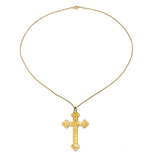 42A - A 9ct yellow gold cross shaped pendant, with engraved decoration, 5.5 by 4.5 by 0.2cm, on a trace li... 