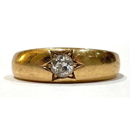 45A - A yellow gold solitaire diamond gypsy ring, the round cut stone 3.5 by 2.5mm, 0.18 ct, in star cut s... 