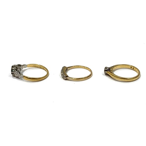 43A - A group of three gold rings, comprising an 18ct yellow gold diamond solitaire ring, the round cut st... 