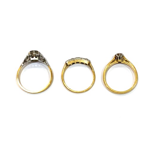 43A - A group of three gold rings, comprising an 18ct yellow gold diamond solitaire ring, the round cut st... 