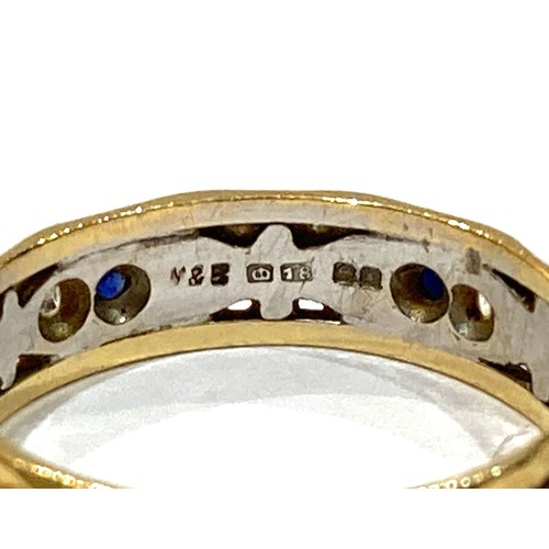 65A - A group of three gold rings, comprising an 18ct white and yellow gold ring set with small dark blue ... 