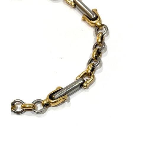 73A - A yellow gold and platinum equestrian theme bracelet, with links in the shape of stirrups, spurs, an... 