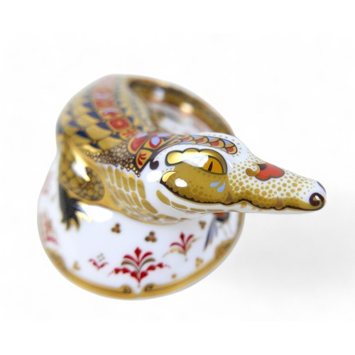 185 - A Royal Crown Derby paperweight, modelled as 'Crocodile', with gold stopper, boxed.