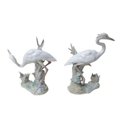 182 - A pair of Lladro heron candlesticks, a Copenhagen B&G figure and two further Lladro figures. (5)