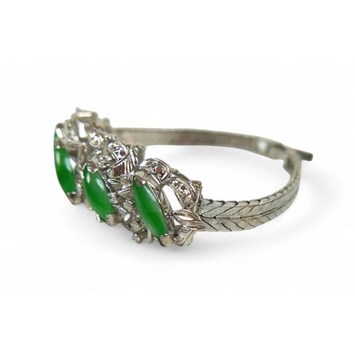 100 - A jade, 18k white gold and diamond bracelet, set in the 1960's, the spray design with five marquise-... 