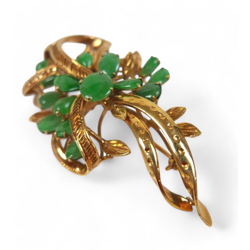 93 - A 10k gold and jade spray brooch, the ribbon and leaf design set with fifteen cabochon jades in oval... 