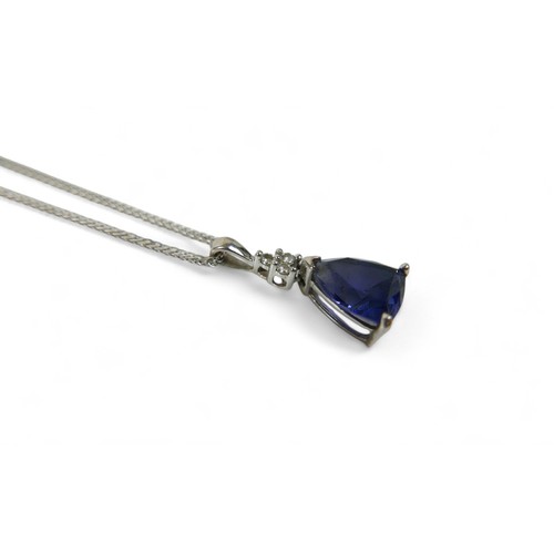 83 - A blue triangular cut sapphire and diamond pendant, on 10k white gold setting, with thin chain, mark... 