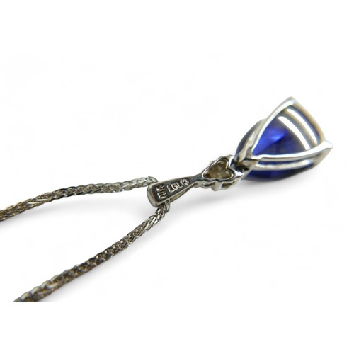 83 - A blue triangular cut sapphire and diamond pendant, on 10k white gold setting, with thin chain, mark... 