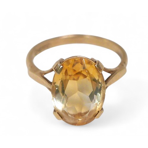 62 - A 9ct gold citrine dress ring, the oval cut stone approximately, 10 by 14mm, size M, 3.3g, with orig... 