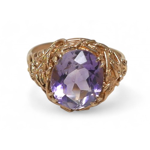 63 - A 9ct gold amethyst ring, the oval cut stone approximately 10 by 12mm, size P, 5.2g.