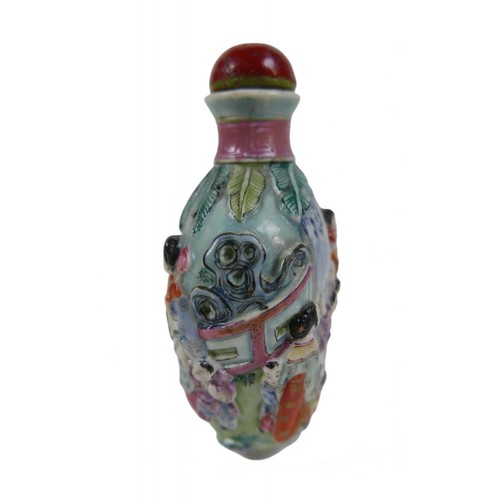 146 - A Chinese relief decorated porcelain snuff bottle, 5 by 4 by 9cm high, signature to base.