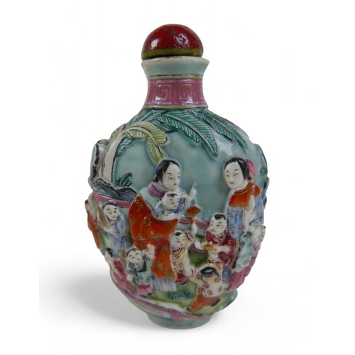 146 - A Chinese relief decorated porcelain snuff bottle, 5 by 4 by 9cm high, signature to base.