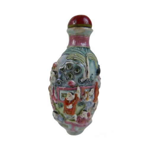 146 - A Chinese relief decorated porcelain snuff bottle, 5 by 4 by 9cm high, signature to base.