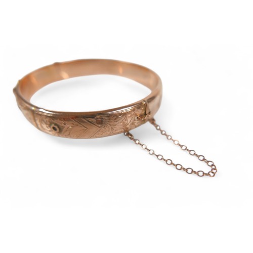 78 - A 9ct rose gold hollow bangle, in the form of a belt, 7 by 6 by 1cm external, with box, 11.3g.