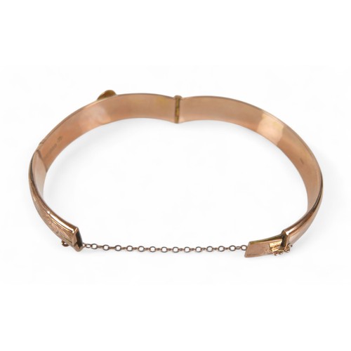 78 - A 9ct rose gold hollow bangle, in the form of a belt, 7 by 6 by 1cm external, with box, 11.3g.