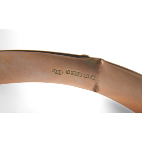 78 - A 9ct rose gold hollow bangle, in the form of a belt, 7 by 6 by 1cm external, with box, 11.3g.