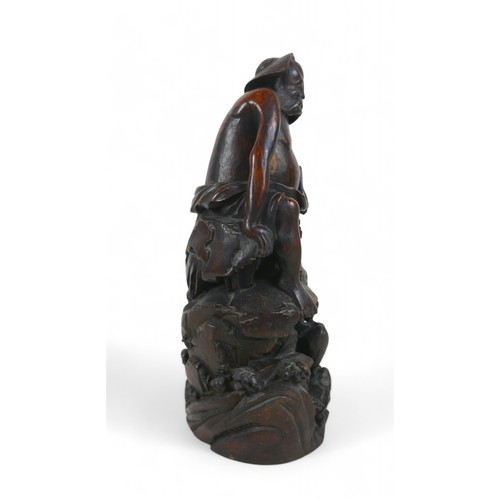 147 - A carved root wood Oriental figure, 13 by 12 by 31cm high.