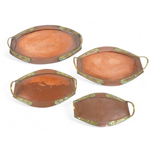 135 - A set of four graduating brass and copper trays, largest 51 by 35 by 3cm high.