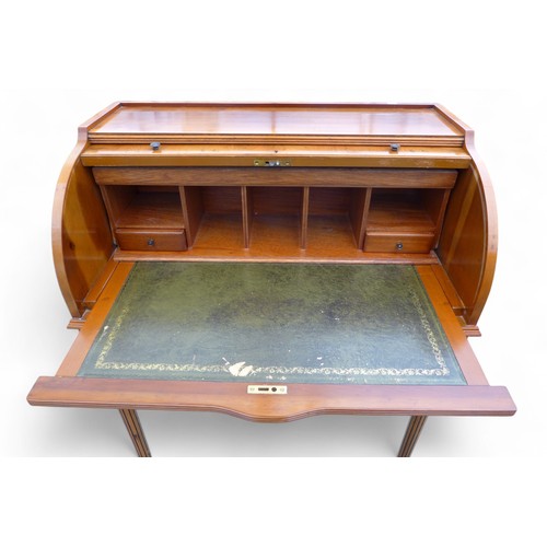 244 - A 20th century yew wood cylinder top writing desk, with a fitted interior above a drawer on turned r... 