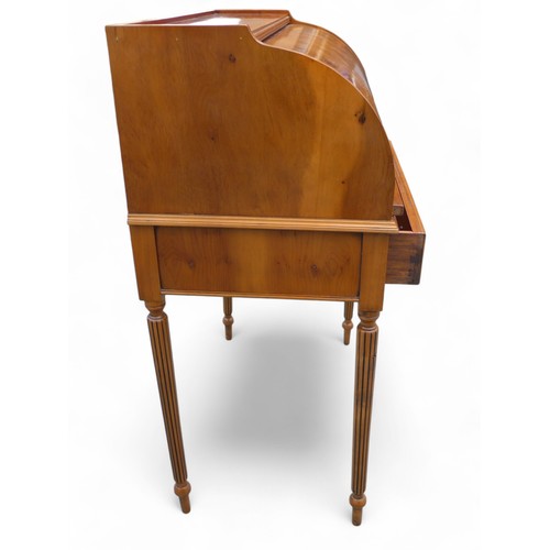 244 - A 20th century yew wood cylinder top writing desk, with a fitted interior above a drawer on turned r... 