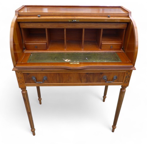 244 - A 20th century yew wood cylinder top writing desk, with a fitted interior above a drawer on turned r... 