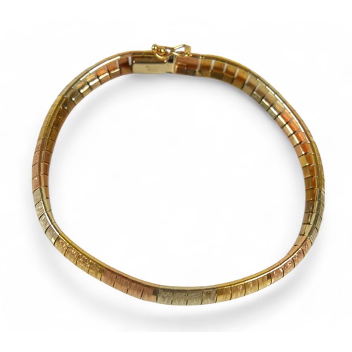 102 - An 18ct gold three-colour bracelet, with reticulated textured segments, South African, marked 750, s... 