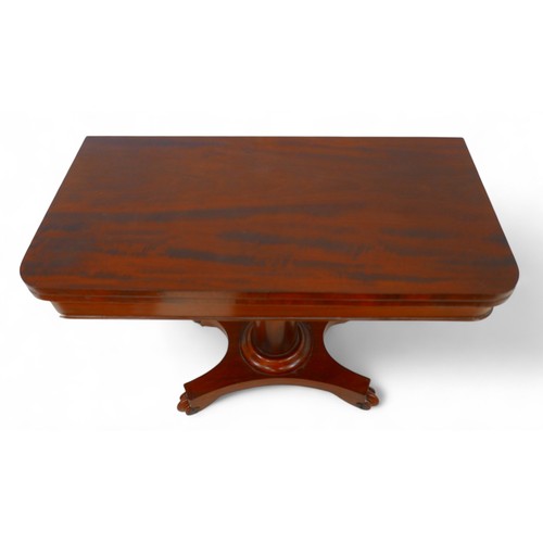 195 - A 19th century mahogany fold over card table on a turned support and quatrefoil platform base on scr... 