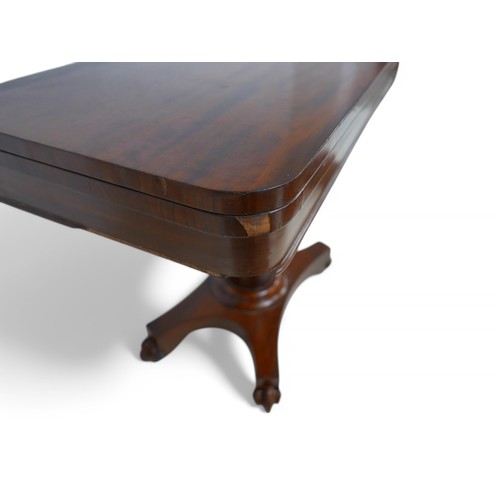 195 - A 19th century mahogany fold over card table on a turned support and quatrefoil platform base on scr... 