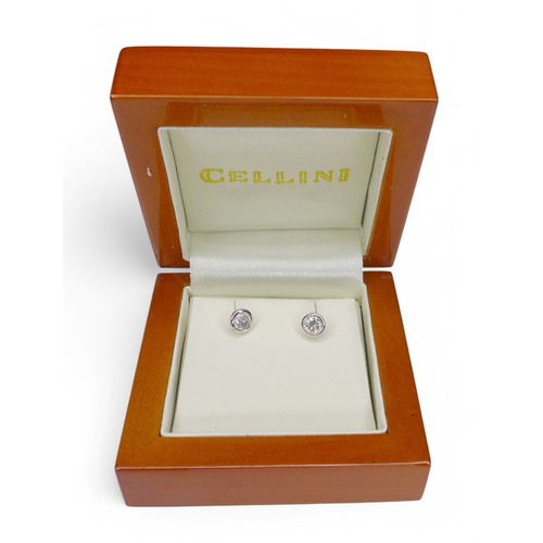 55 - A pair of 14ct white gold diamond stud earrings, head size 5mm diameter, weight 1.2g.