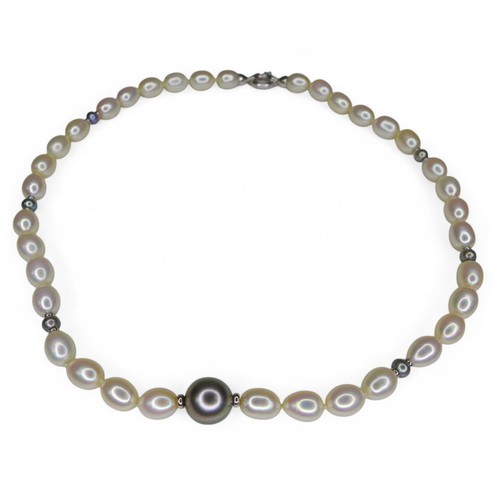 56 - A pearl necklace on 18ct white gold clasp, the single  strand comprising oval pearls interspersed wi... 