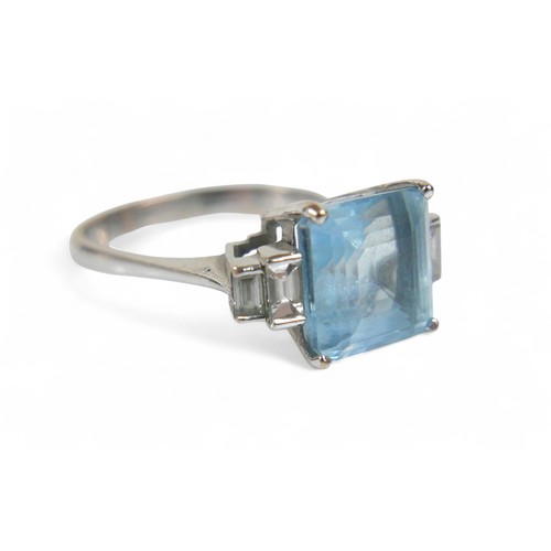 79 - An 18ct white gold, diamond and aquamarine ring,  set with a princess-cut aquamarine 9mmx9mm flanked... 