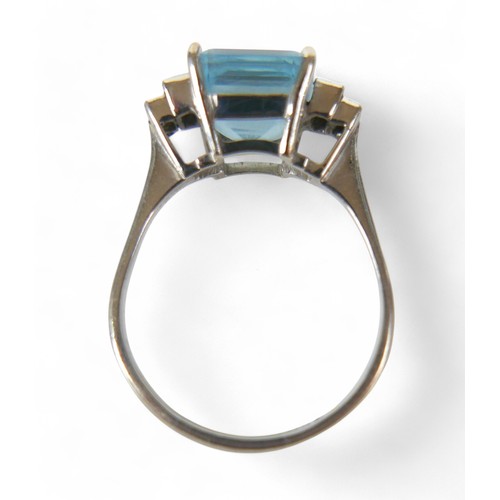 79 - An 18ct white gold, diamond and aquamarine ring,  set with a princess-cut aquamarine 9mmx9mm flanked... 