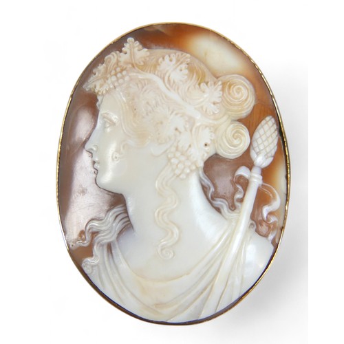 58 - A large oval cameo brooch, circa 1900, carved with the head of a Bacchante maiden facing left, Greci... 