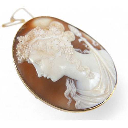 58 - A large oval cameo brooch, circa 1900, carved with the head of a Bacchante maiden facing left, Greci... 