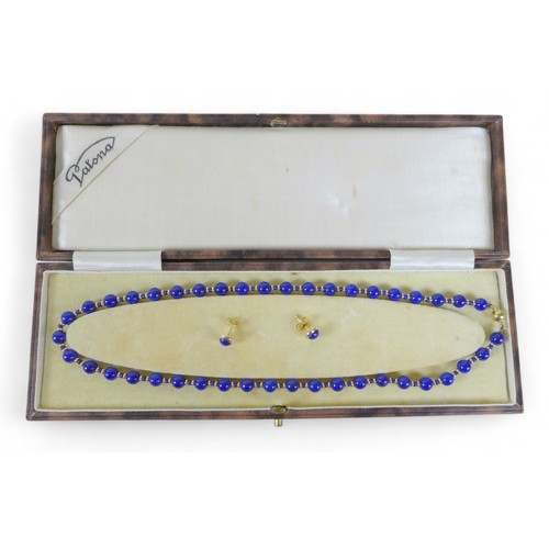 43 - A lapis lazuli bead necklace on 18ct gold clasp, the beads interspersed with gold spacer beads, mark... 