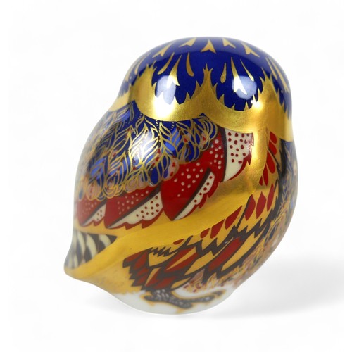 110 - A group of three Royal Crown Derby paperweights, comprising a cheetah, an owl, and a goldcrest. (3)