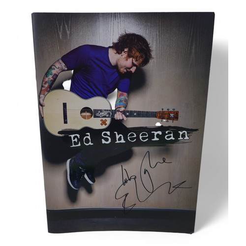 128 - Ed Sheeran a signed T-shirt Wembley July 2015 and a signed program with ticket. (3)