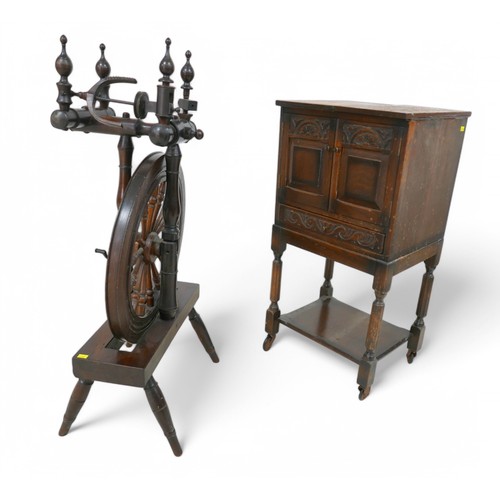 196 - A carved oak sewing box and an 18th century spinning wheel, box measures 38 by 34 by 76cm high.(2)