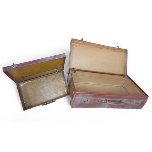 187 - Two vintage leather suitcases, largest 70 by 38 by 18cm. (2)