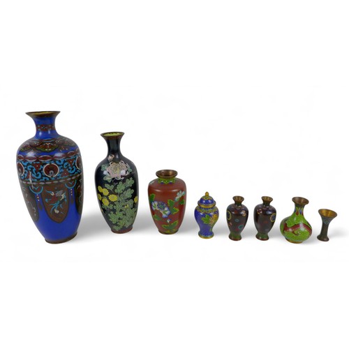 116 - A collection of nineteen cloisonné vases, pots, serviette rings and a charger, largest vase 13cm dia... 