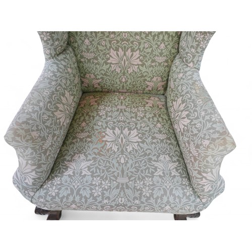 199 - Two wing back upholstered armchairs, both on carved front legs, largest 78 by 82 by 107cm high. (2)