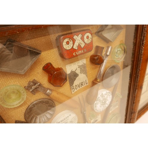 125 - Three interesting showcases, containing till/price labels, theatre memorabilia and pots lids with ut... 