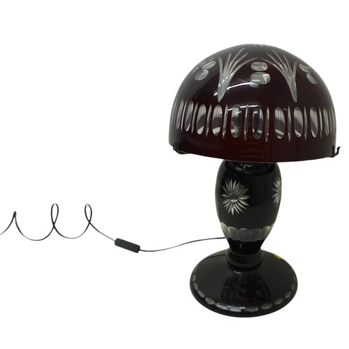 233 - A ruby overlay cut glass table lamp and shade, 30cm diameter by 46cm high.