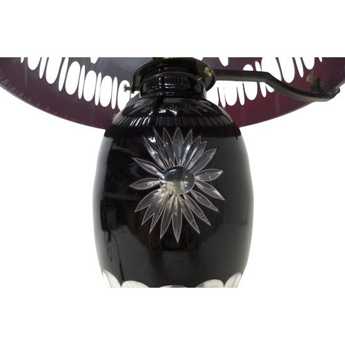 233 - A ruby overlay cut glass table lamp and shade, 30cm diameter by 46cm high.