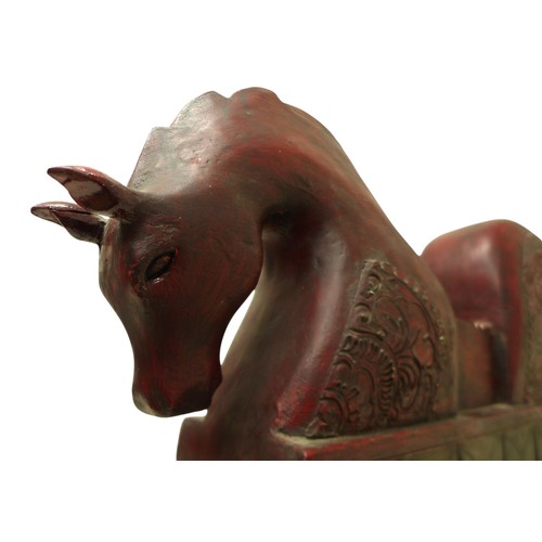 222 - A carved wooden horse figure, on a metal stand 64 by 12 by 47cm high.