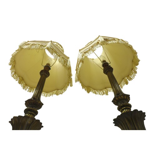 236 - A pair of classical style gilt metal table lamps with shades, 32 by 78cm high.